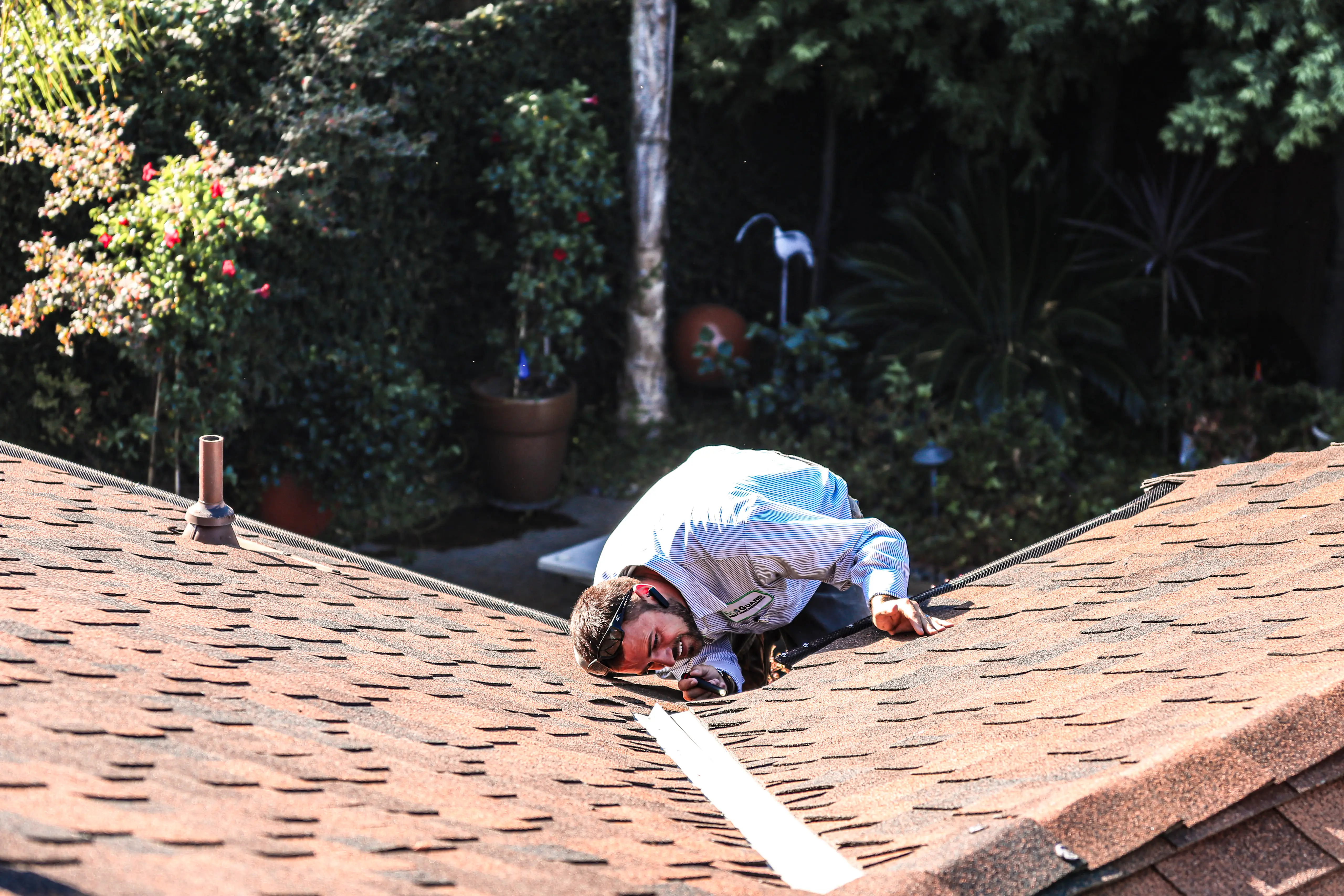 Technician sealing rodent entry point on home exterior