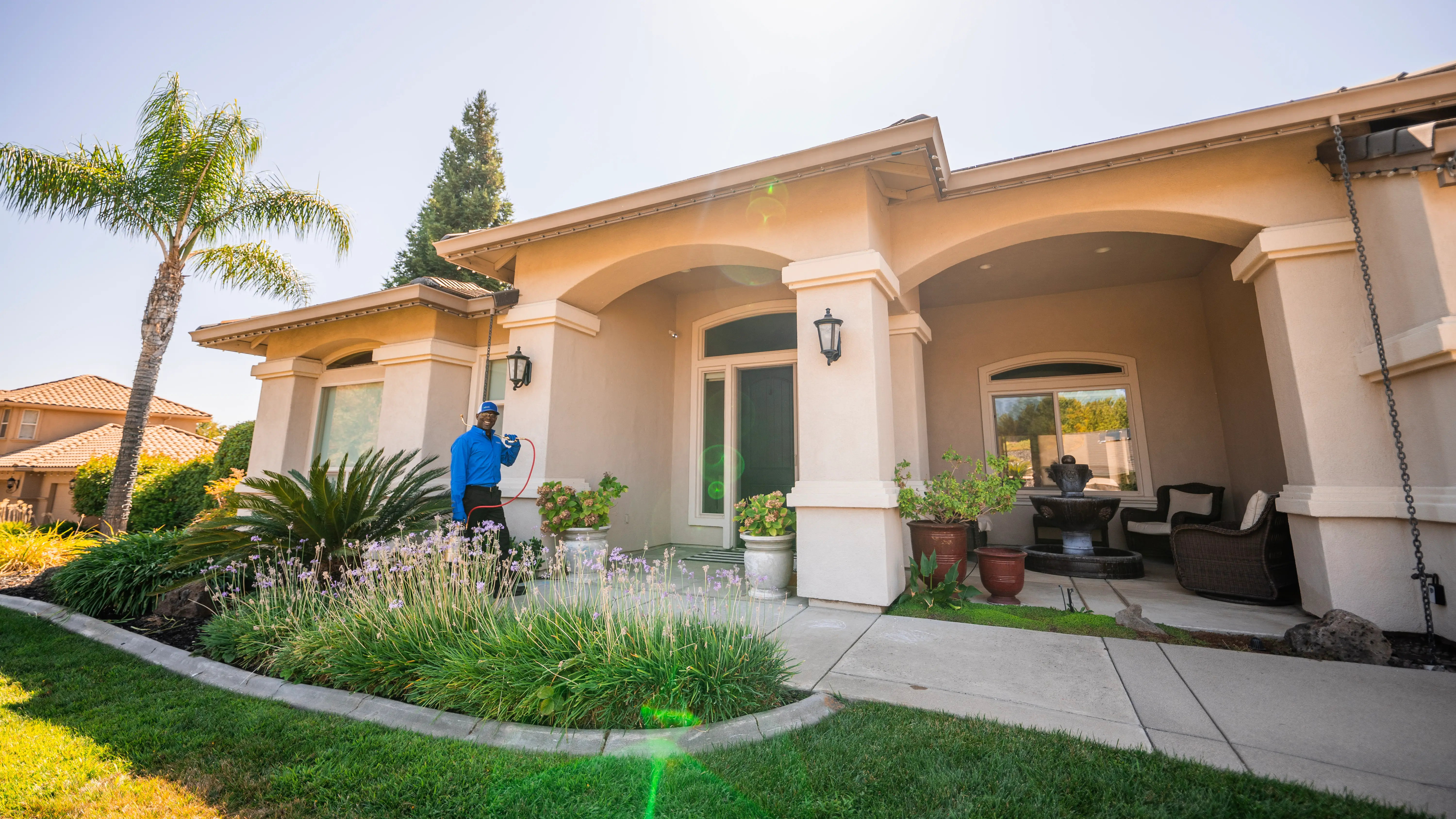 Applying all-natural organic tick treatment to yard